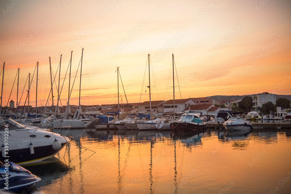 There are many yachts, boats and ships at sea. Marina at sunset. Vosice Croatia Gorgeous summer sunset by the ocean