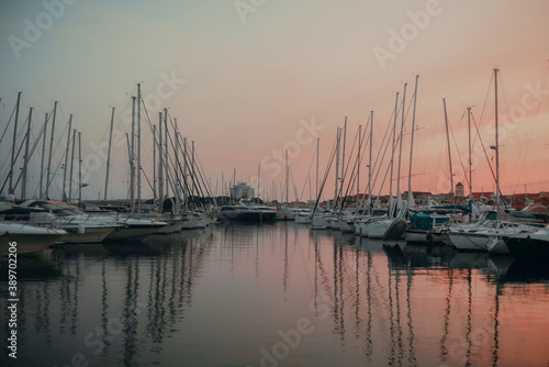 There are many yachts  boats and ships at sea. Marina at sunset. Vosice Croatia Gorgeous summer sunset by the ocean