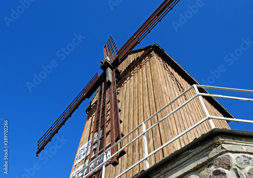 Grain mill Kozlak windmill standing by the Bug River in the village of Brok in Masovia, Poland on a white background an inscription advertising grandma's kitchen photo