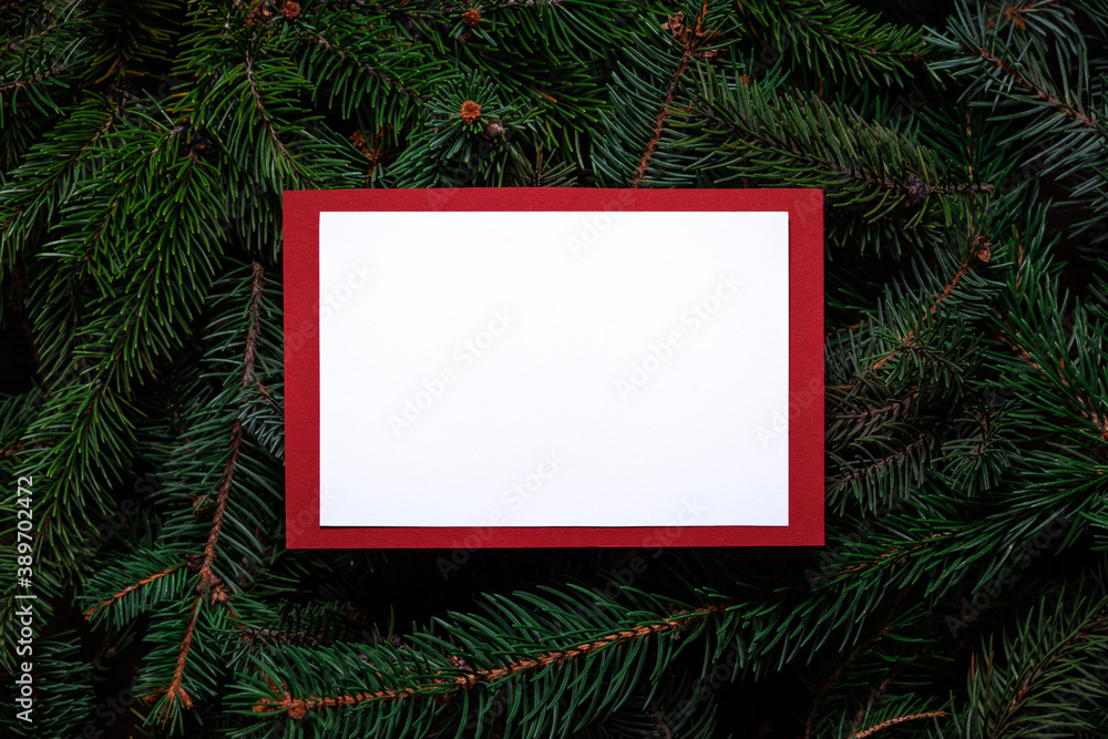 Christmas tree branches with paper card note. Nature New Year concept. Merry Christmas card, background. Congratulations, holidays, celebration. Mock up, copy space, flat lay. Red, green and white. Christmas tree branches with paper card note. Nature New Year concept. Merry Christmas card, background. Congratulations, holidays, celebration. Mock up, copy space, flat lay. Red, green and white.