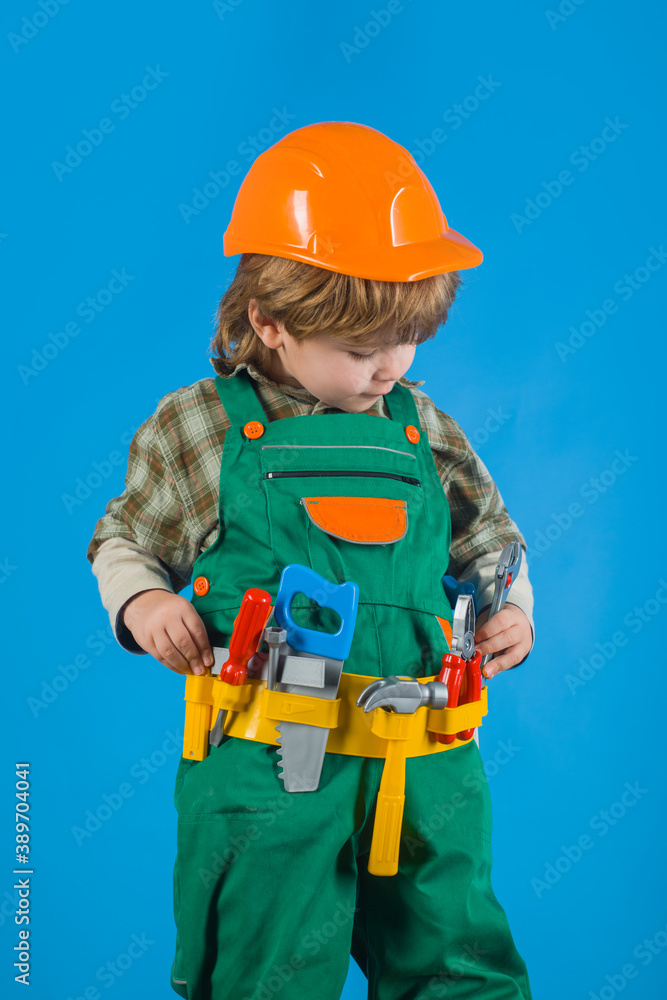 Tools for building. Kid repairman. Builder boy in helmet and tools. Child game. Little boy in builder's uniform tool belt. Work with tools. Repair. Kid boy as builder or repairer. Tools for building. Kid repairman. Builder boy in helmet and tools. Child game. Little boy in builder's uniform tool belt. Work with tools. Repair. Kid boy as builder or repairer.