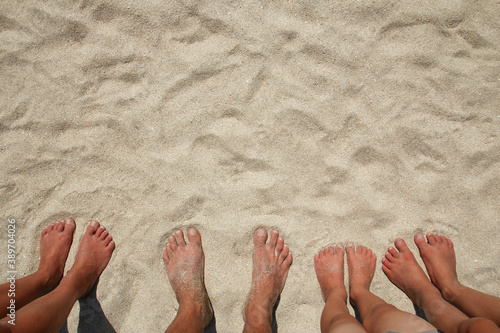 A Feet on the sand of happy people by the sea on nature travel