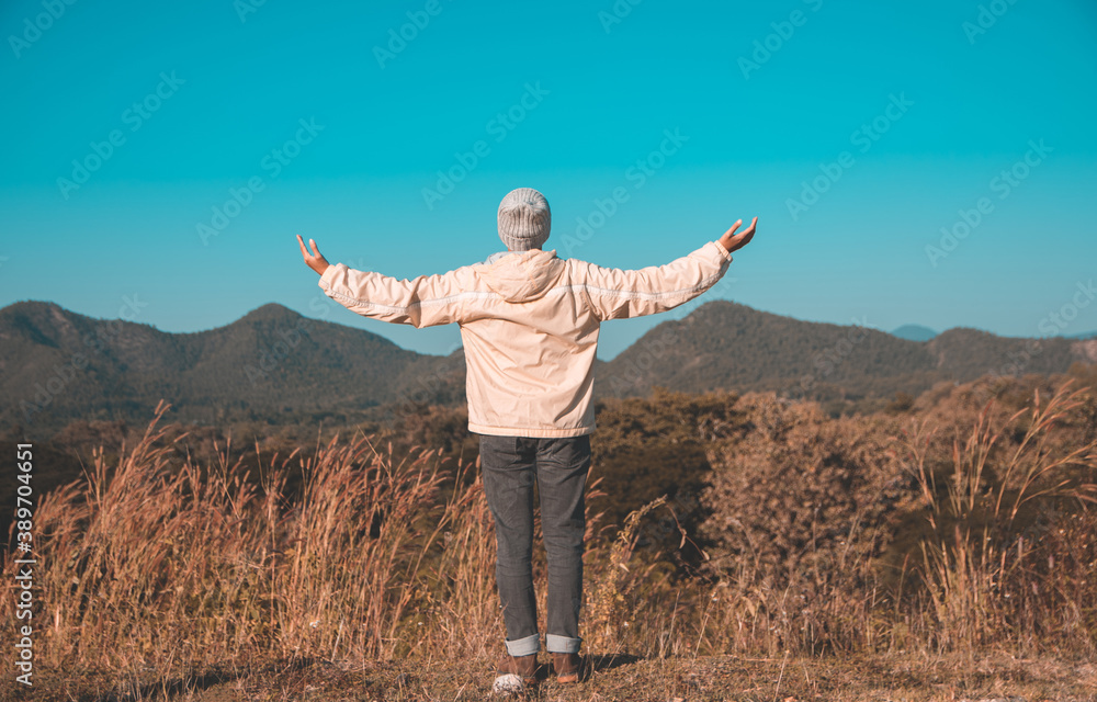 Focus blur Asian young men 25-30 year selfie standing open arm hiking happy with mountain blue sky landscape nature hiking outdoor at lamphun Thailand Focus blur Asian young men 25-30 year selfie standing open arm hiking happy with mountain blue sky landscape nature hiking outdoor at lamphun Thailand