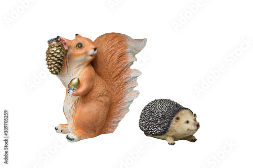 Plaster classical garden figure. Isolated over white background. Set Hedgehog and squirrel with golden forest cones. Blank for the designer. photo