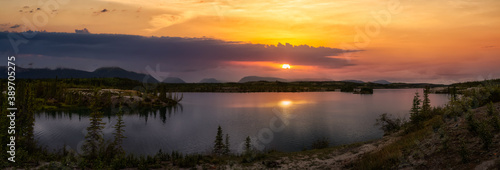 Panoramic Beautiful View of Lewes Lake during fall season. Colorful Sunset Artistic Render. Located near Whitehorse, Carcross, Yukon, Canada. Nature Background Panorama