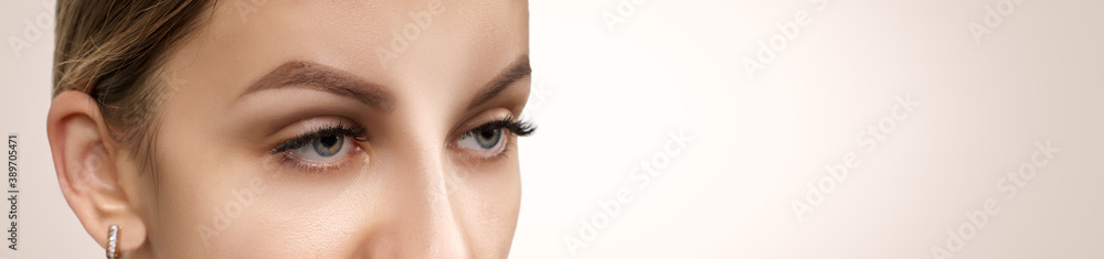 Eyelash Extension Procedure. Beautiful Woman with Extreme Long False Eyelashes. Makeup, Cosmetics. Beauty, Skincare.