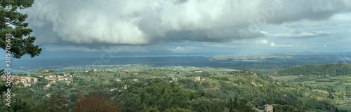 aerial landscape with stormy clouds over Trasimeno lake shot from Montepulciano historical town, Siena, Italy