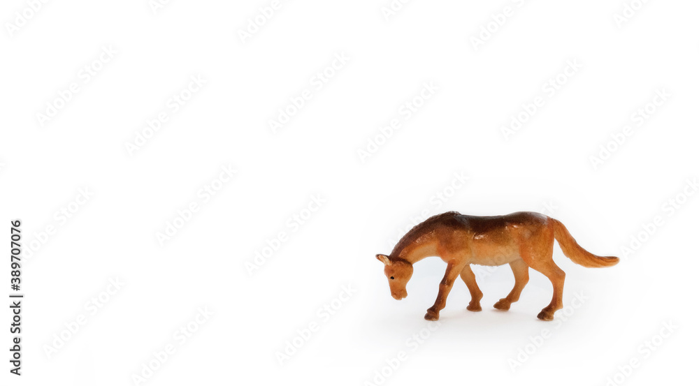 Fototapeta premium Toy horse model isolated on white background. Small cute toy close-up.