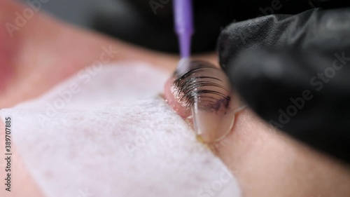 Beautiful young woman during eyelashes lamination, closeup