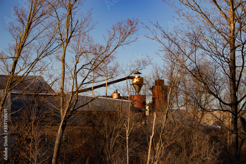 Old building and machinery along a bike path.