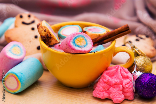 cup of chocolte with marshmallows and gingerbread man and gingerbread cookie on bokeh background. Christmas banner.