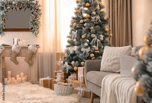 Beautiful Christmas tree in decorated living room. Festive interior