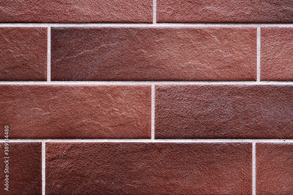Fototapeta premium Texture of brown wall of decorative tiles or bricks.