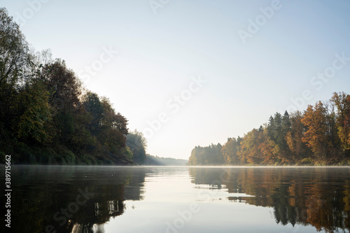 Autumn landscape of a wide river with water