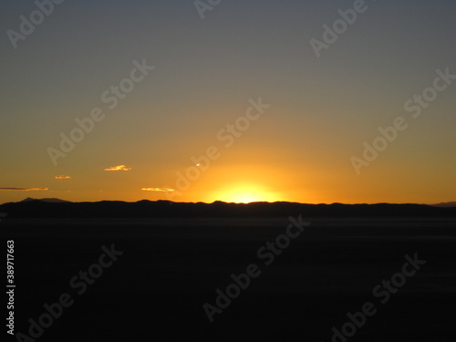 Sunset over the stunning salt flats  desert and mountain landscapes around Salar de Uyuni in Bolivia  South America