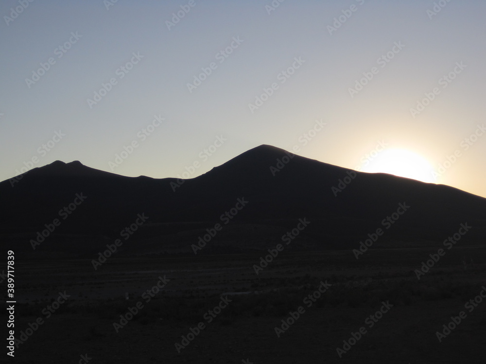 Sunset over the stunning salt flats, desert and mountain landscapes around Salar de Uyuni in Bolivia, South America