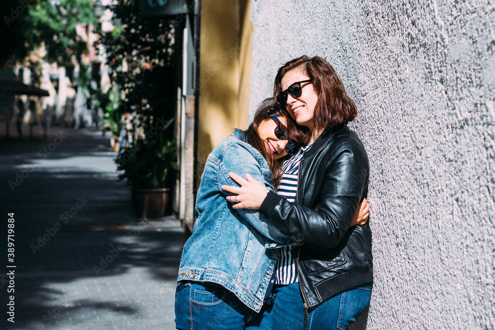couple of women hugging in the street