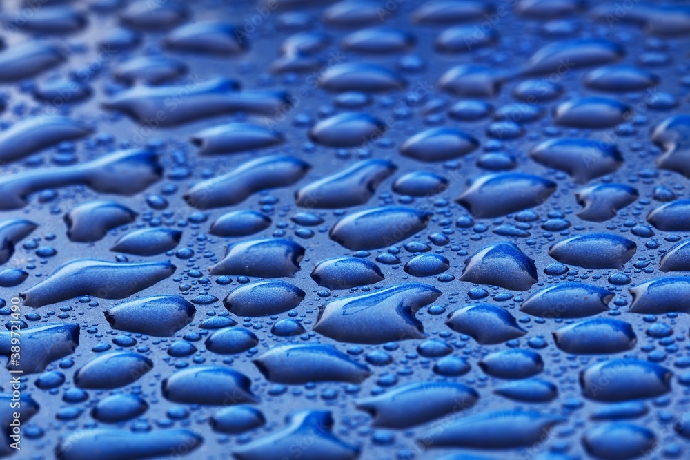 Dark blue background, crystal clear water drops (raindrops). Abstract
