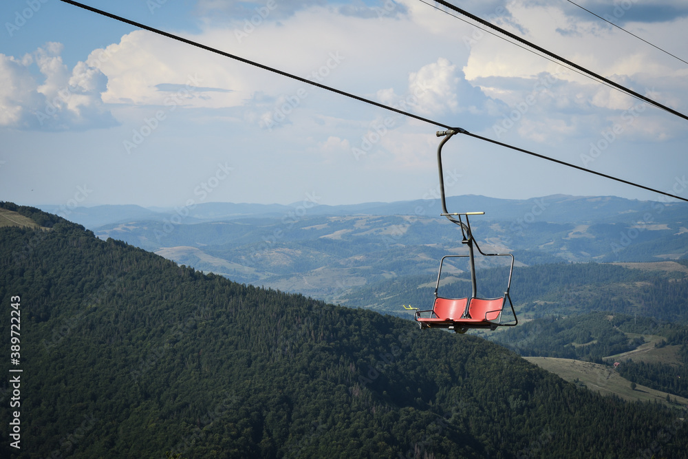 Empty chairlift on a background of beautiful autumn mountains