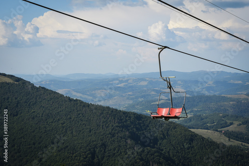 Empty chairlift on a background of beautiful autumn mountains