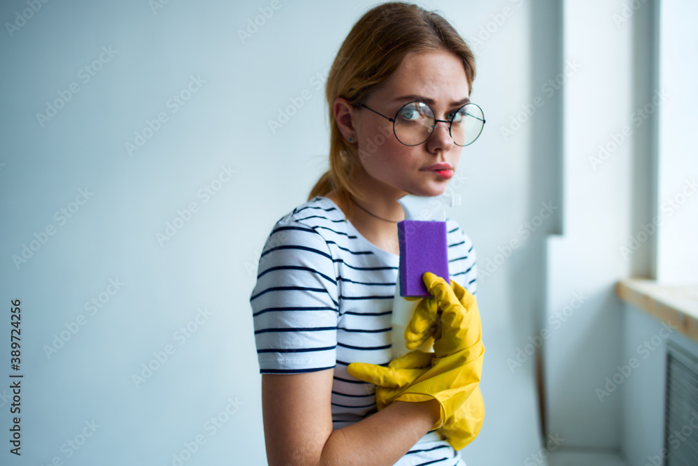 cleaning lady with a sponge in her hands home care service detergent window cleaning cleaning lady with a sponge in her hands home care service detergent window cleaning