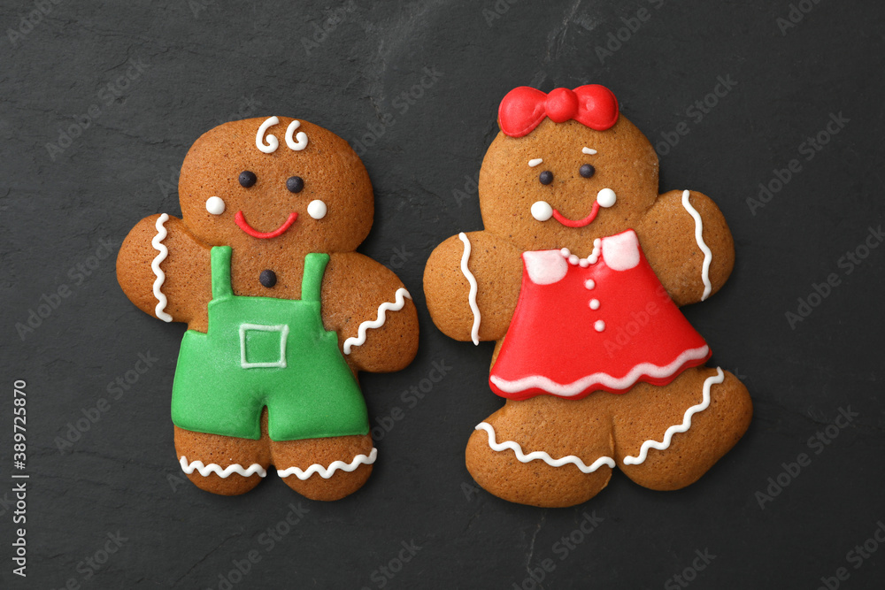 Gingerbread man and woman on black table, flat lay. Delicious Christmas cookies Gingerbread man and woman on black table, flat lay. Delicious Christmas cookies