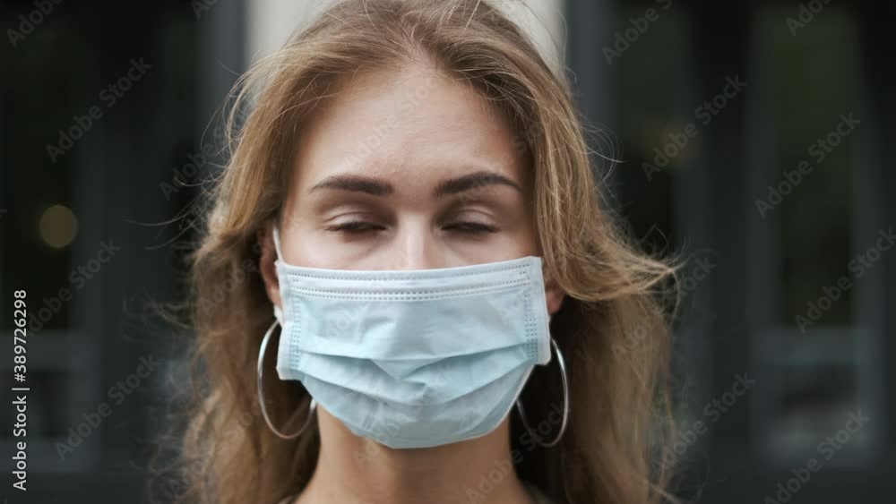 Attractive woman in mask closeup looking at camera background building with columns. coronavirus covid 19. View masked face girl pandemic covid-19. Person in masks serious look on street corona virus.