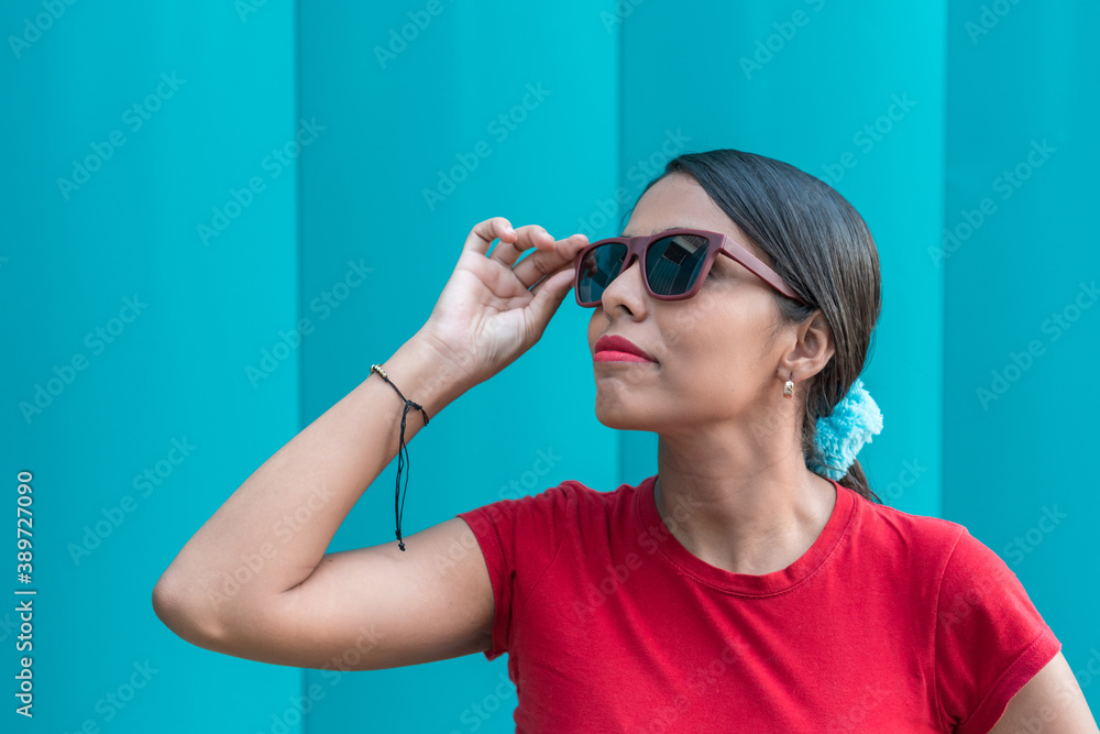 Hispanic brunette with long hair and sunglasses facing away Hispanic brunette with long hair and sunglasses facing away