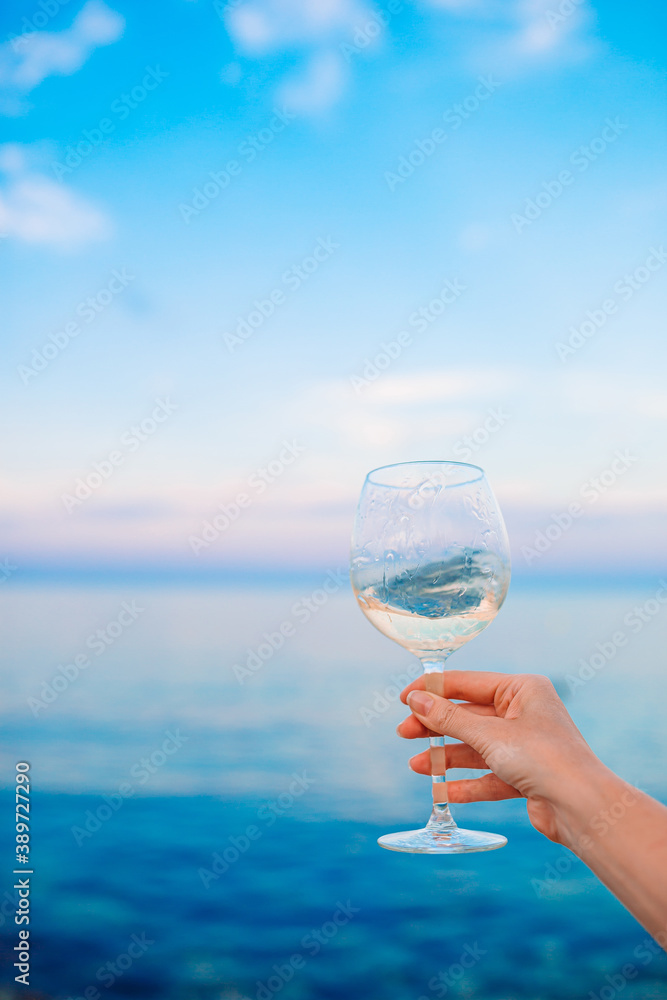 Fototapeta Glass of white wine on tropical beach