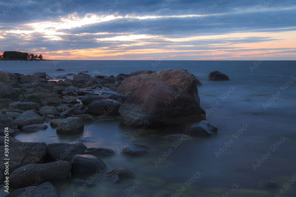 Blue hour view of Baltic sea coast with erratic boulders covered with seaweed. Blue hour view of Baltic sea coast with erratic boulders covered with seaweed.