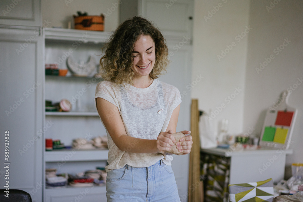 young curly girl in a pottery workshop makes a vase young curly girl in a pottery workshop makes a vase