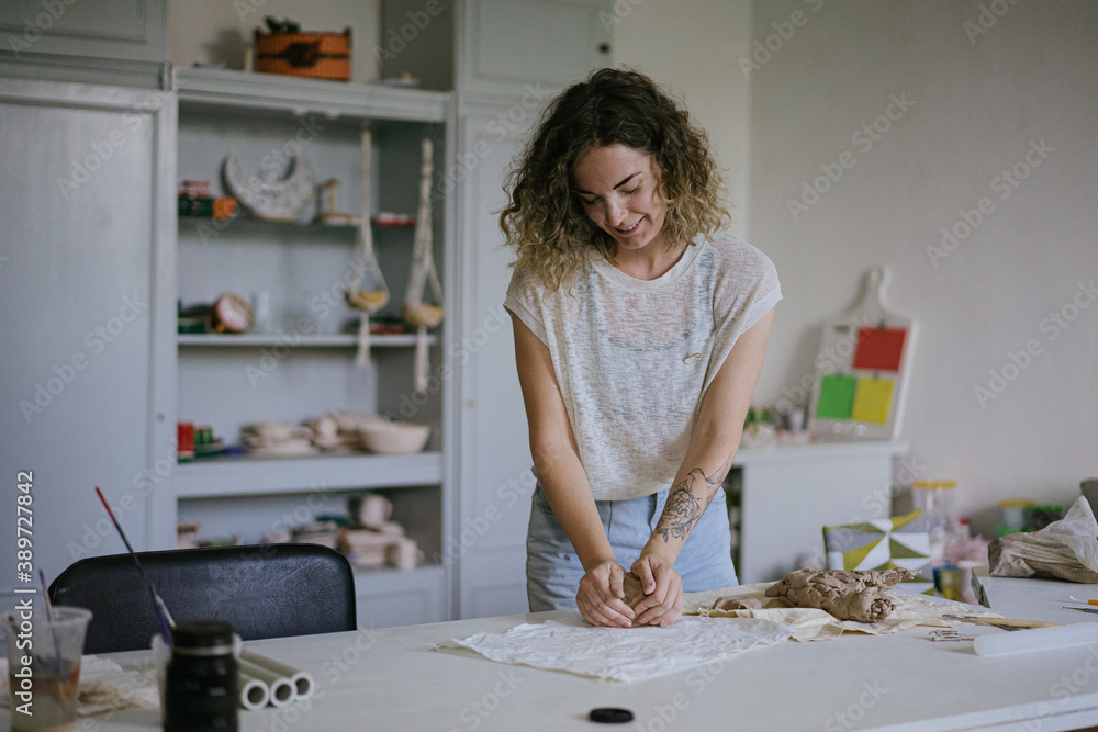 young curly girl in a pottery workshop makes a vase young curly girl in a pottery workshop makes a vase
