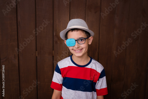 Portrait of boy in glasses with patch. Eye patch for glasses t treat lazy eye, amblyopia, strabismus.	
