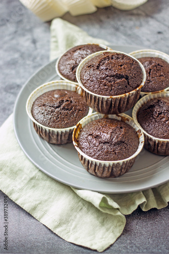Homemade gluten-free muffins with chocolate close-up. Gluten-free flour cupcakes with chocolate on a green plate with a napkin on a dark table. Low Carb Sugar Free Cupcakes