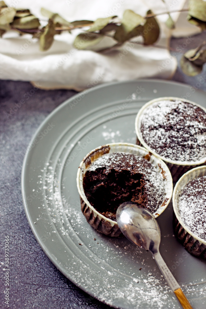 Gluten-free pumpkin chocolate muffins on a gray plate surrounded by ingredients, next to a white card for the inscription. Copy space, flat lay. Healthy baking concept Gluten-free pumpkin chocolate muffins on a gray plate surrounded by ingredients, next to a white card for the inscription. Copy space, flat lay. Healthy baking concept