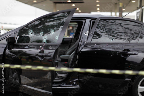 Bullet holes are seen in the window of a car after a armed robbery shot in Sao Paulo, Brazil.