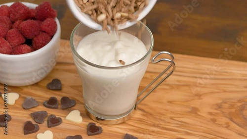 a white yogurt with honet, cereal grain and fresh raspberries photo