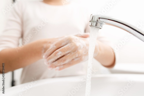 Washing hands with soap.