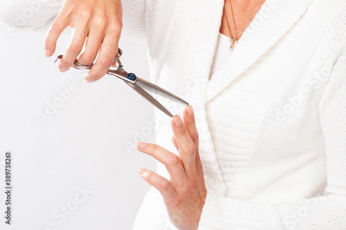 Groomer checks sharpening of metal scissors