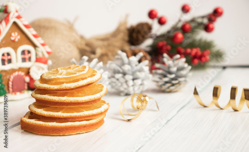 Top view of christmas spices on wooden background with fir branches and copy space