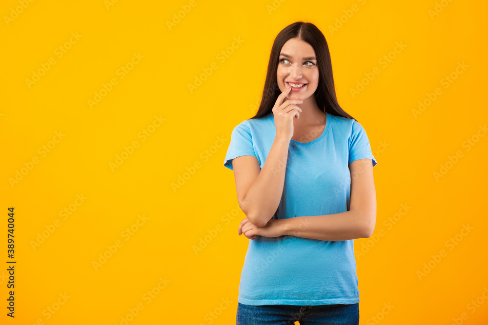 Portrait of smiling woman posing on yellow background Portrait of smiling woman posing on yellow background