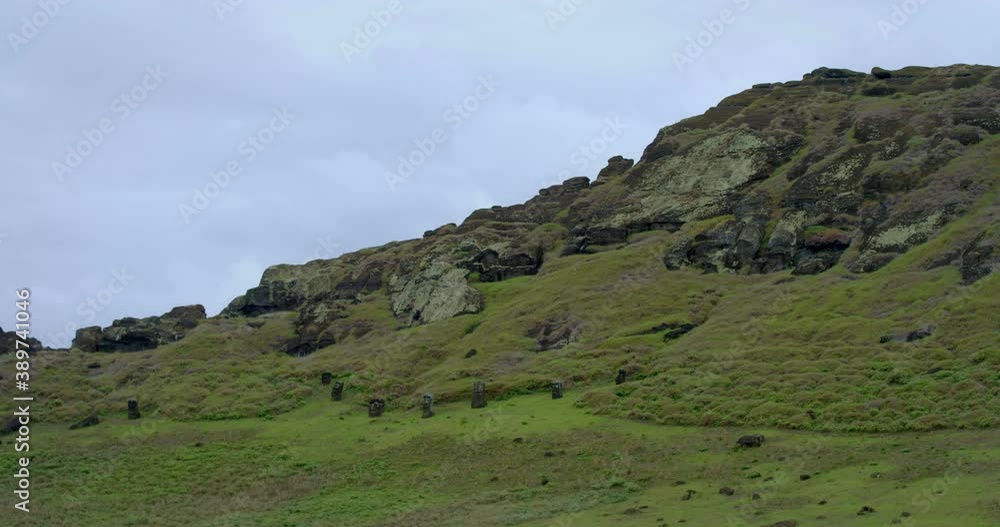 Low angle, Easter Island heads on mountainside in distance Low angle, Easter Island heads on mountainside in distance