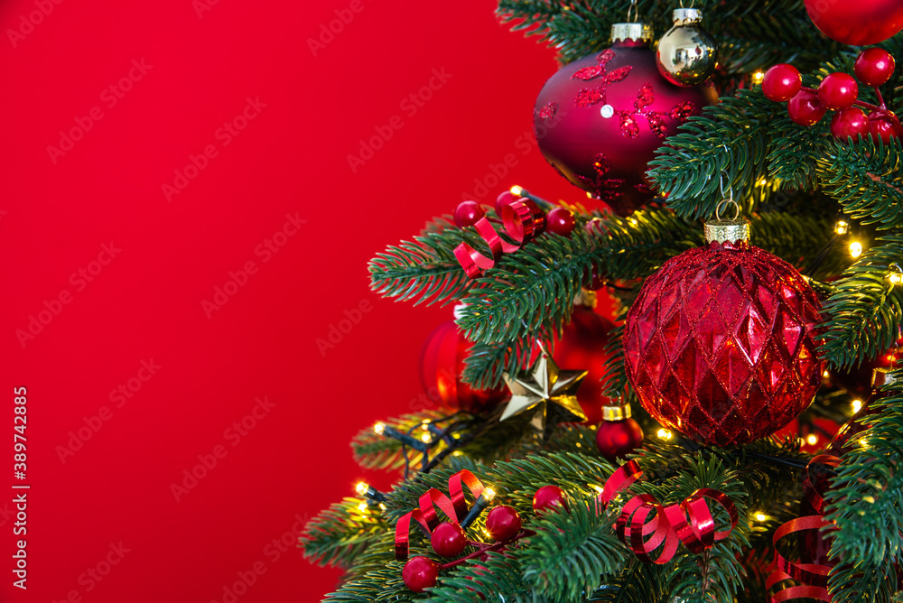 Decorated with ornaments and lights Christmas tree on red background. Merry Christmas and Happy Holidays greeting card, frame, banner. New Year. Noel	
