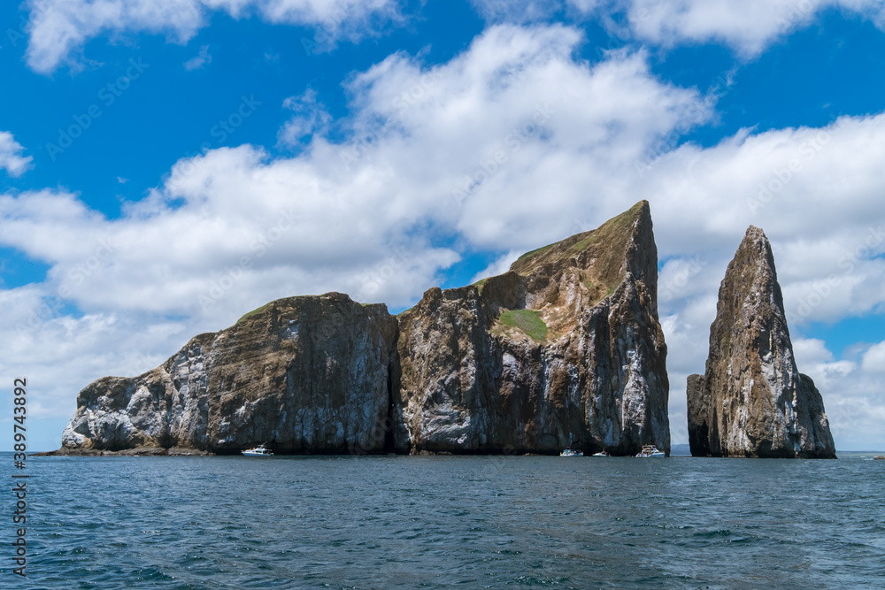 A closeup of Kicker rock island from a boat after a scuba diving experience. The sky is cloudy on a sunny day in San Cristobal Island, at Galapagos Galapagos Islands, Ecuador A closeup of Kicker rock island from a boat after a scuba diving experience. The sky is cloudy on a sunny day in San Cristobal Island, at Galapagos Galapagos Islands, Ecuador