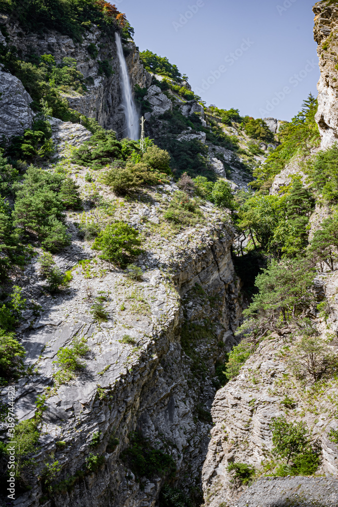 Valley with the Waterfall surrounded by mountains in Swiss Alps, Switzerland