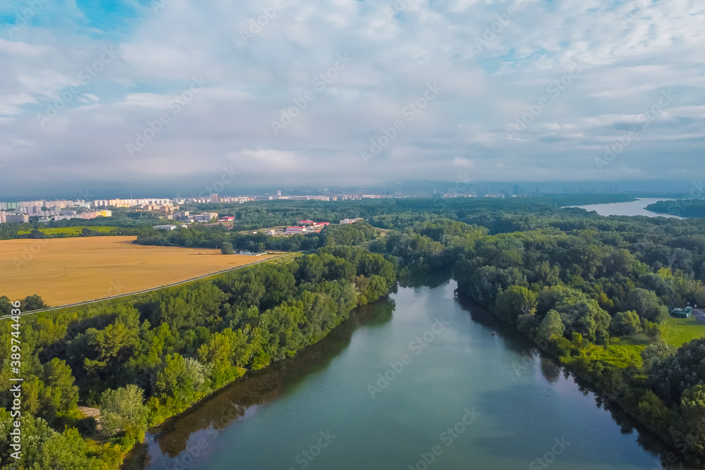 Aerial panorama of donau river close to Bratislava, Slovakia, seen from Petrzalka district on a sunny morning.