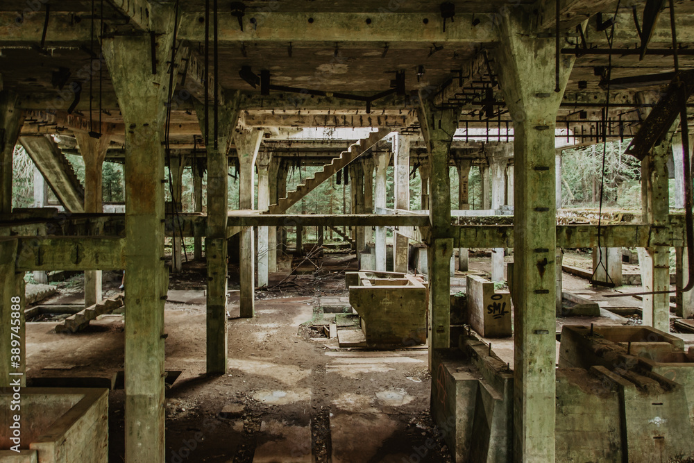 View of abandoned empty buildings of old tin mine. Industrial dirty building interior. Damaged factory in Rolava, Ore mountains,Czech republic