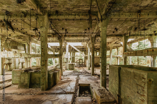 View of abandoned empty buildings of old tin mine. Industrial dirty building interior. Damaged factory in Rolava, Ore mountains,Czech republic