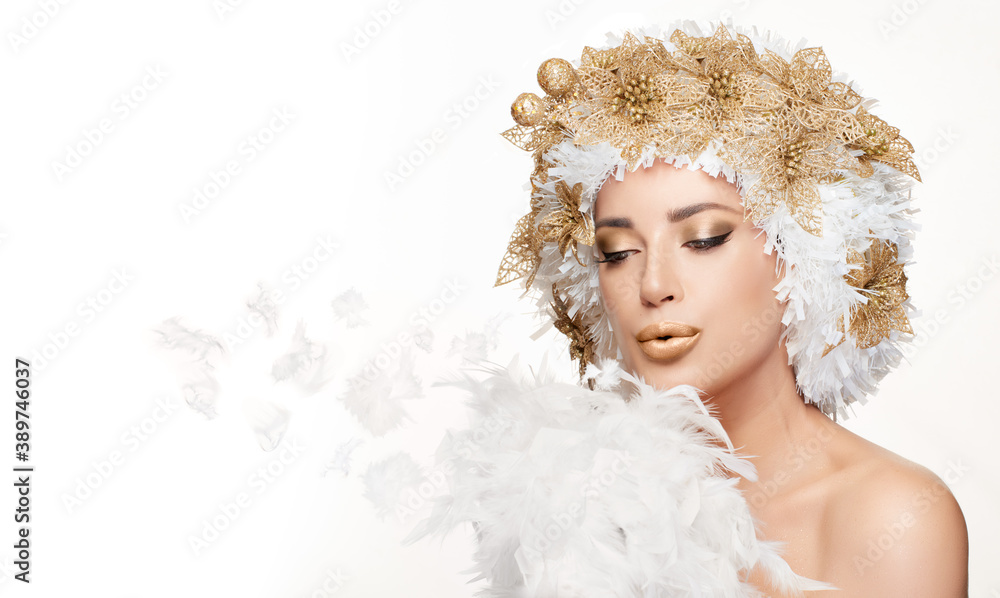Beautiful winter fashion girl with a creative white and gold Christmas hairstyle blowing a kiss Beautiful winter fashion girl with a creative white and gold Christmas hairstyle blowing a kiss