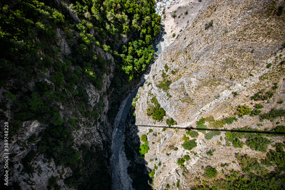 Aerial view of river flowing through forest in alpine valley in Switzerland